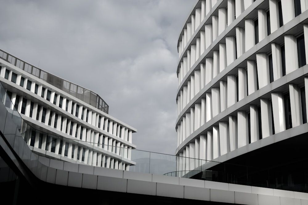 white concrete building under white clouds during daytime