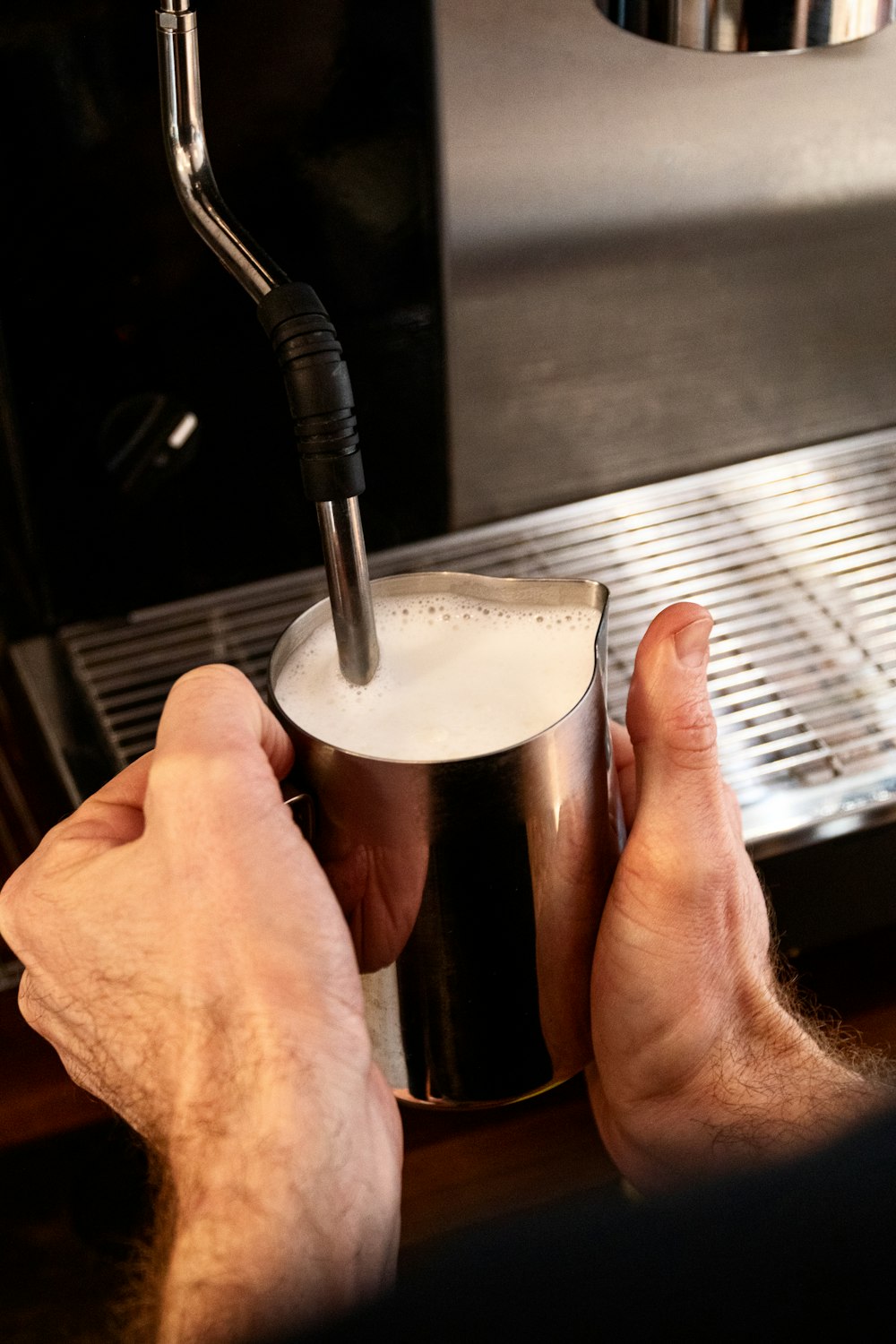 person holding black and white plastic container