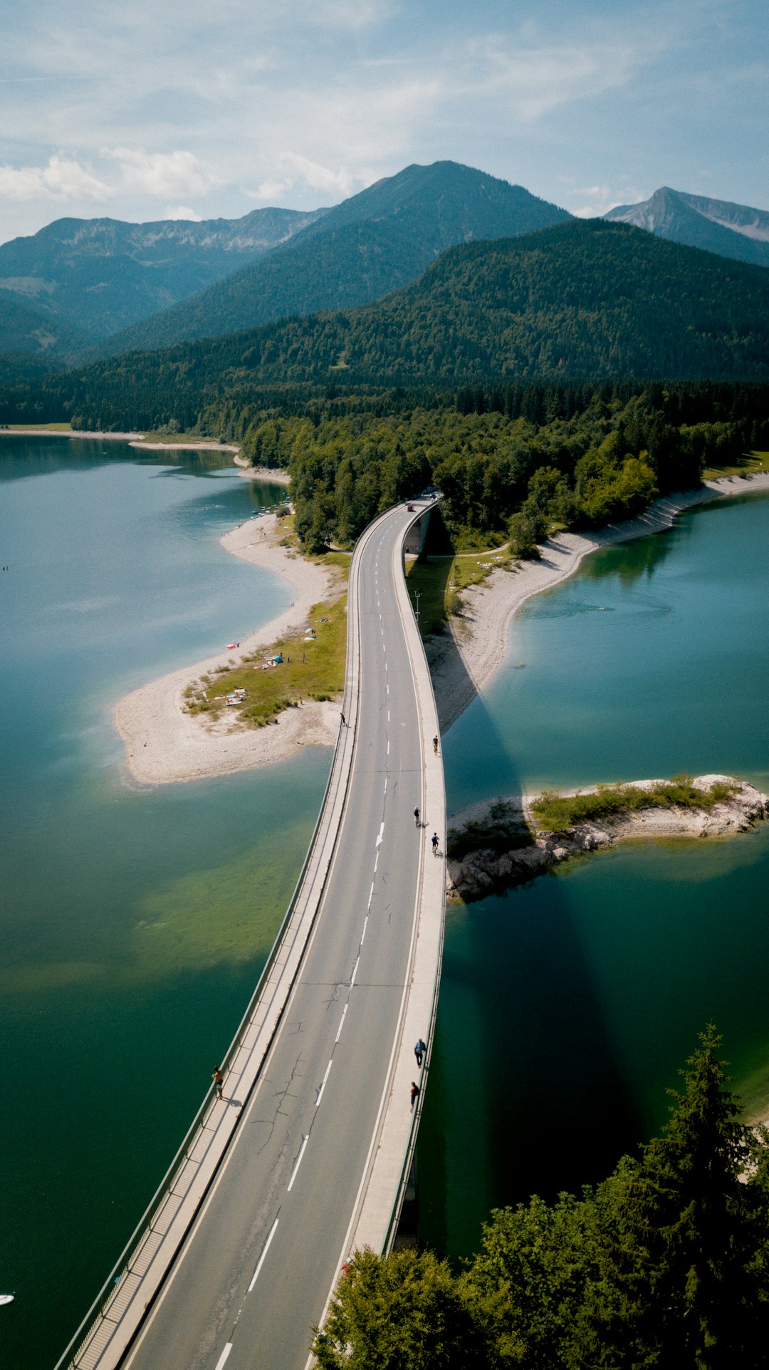 aerial view of road beside body of water during daytime