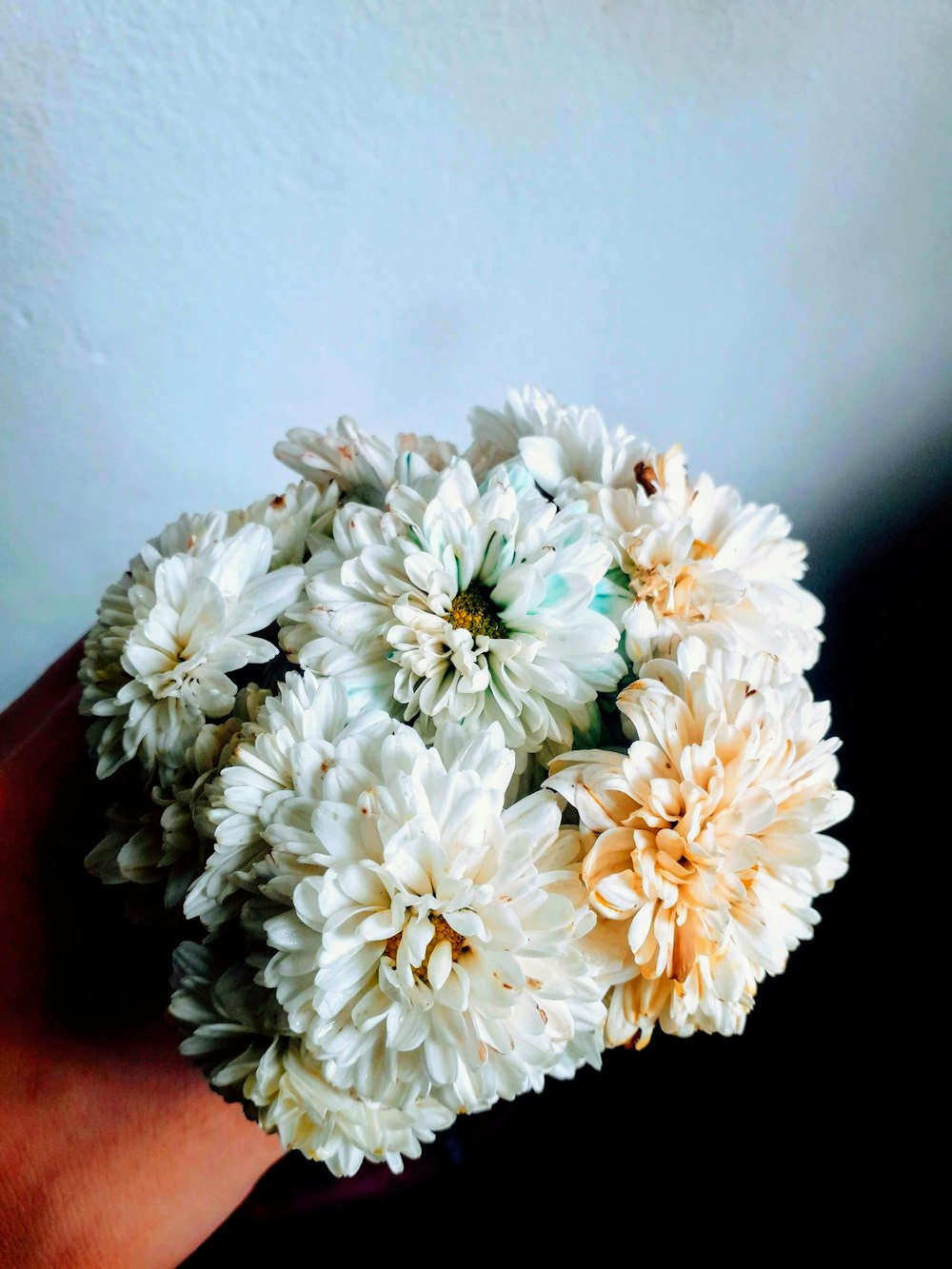 white flower bouquet on red textile