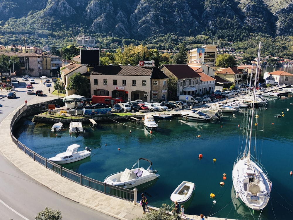 white and blue boat on body of water during daytime