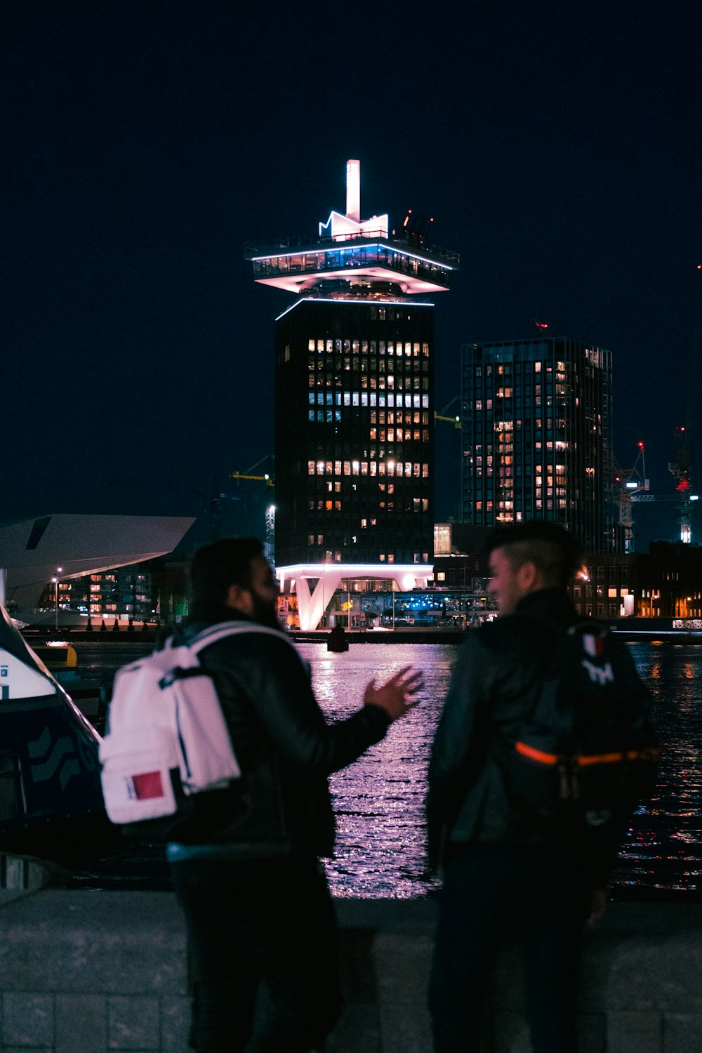 people walking on sidewalk during night time