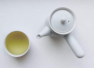 white ceramic teapot beside white ceramic mug