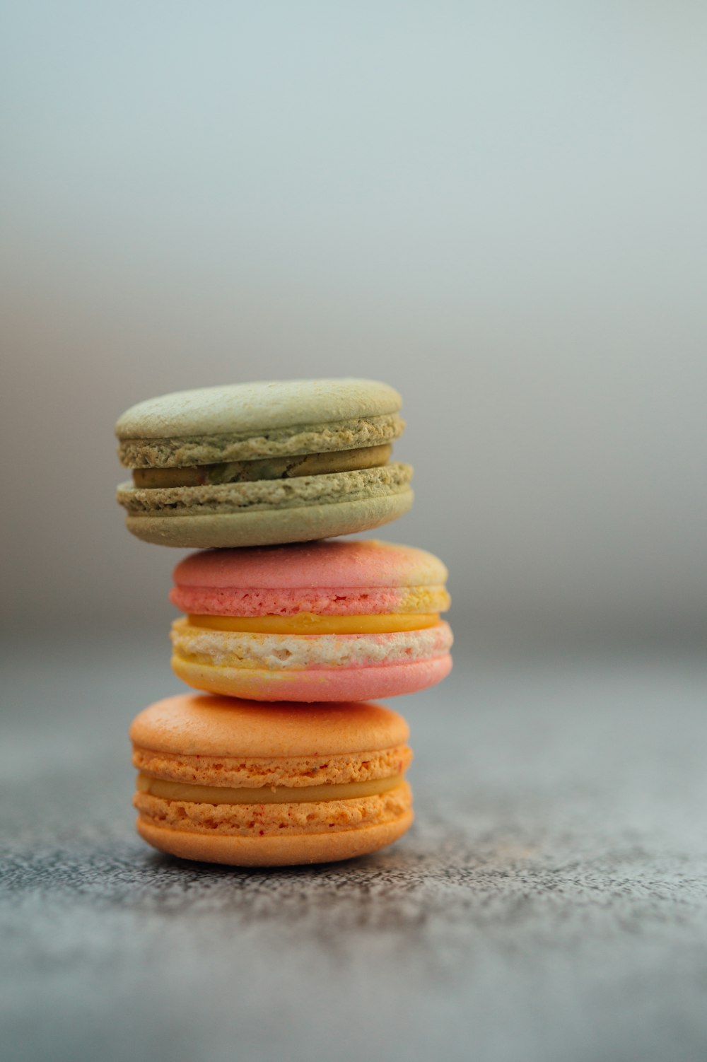 3 stack of macaroons on gray surface