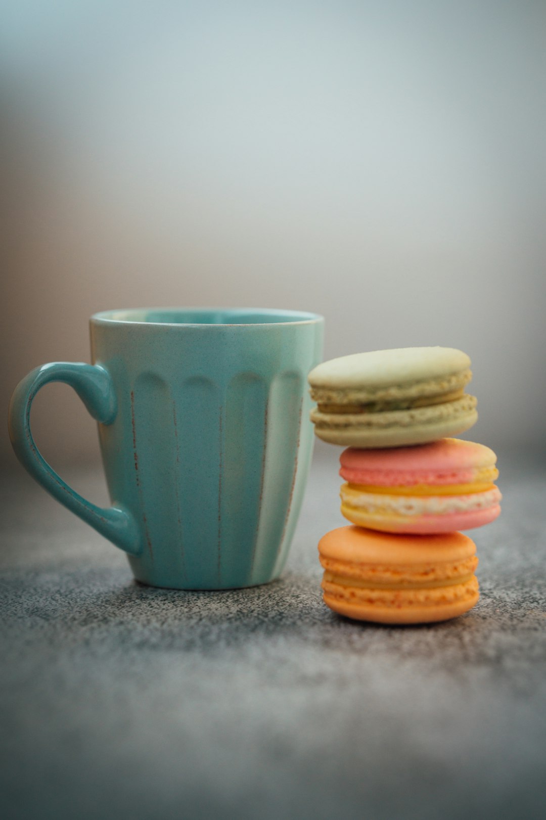blue ceramic mug beside three cookies