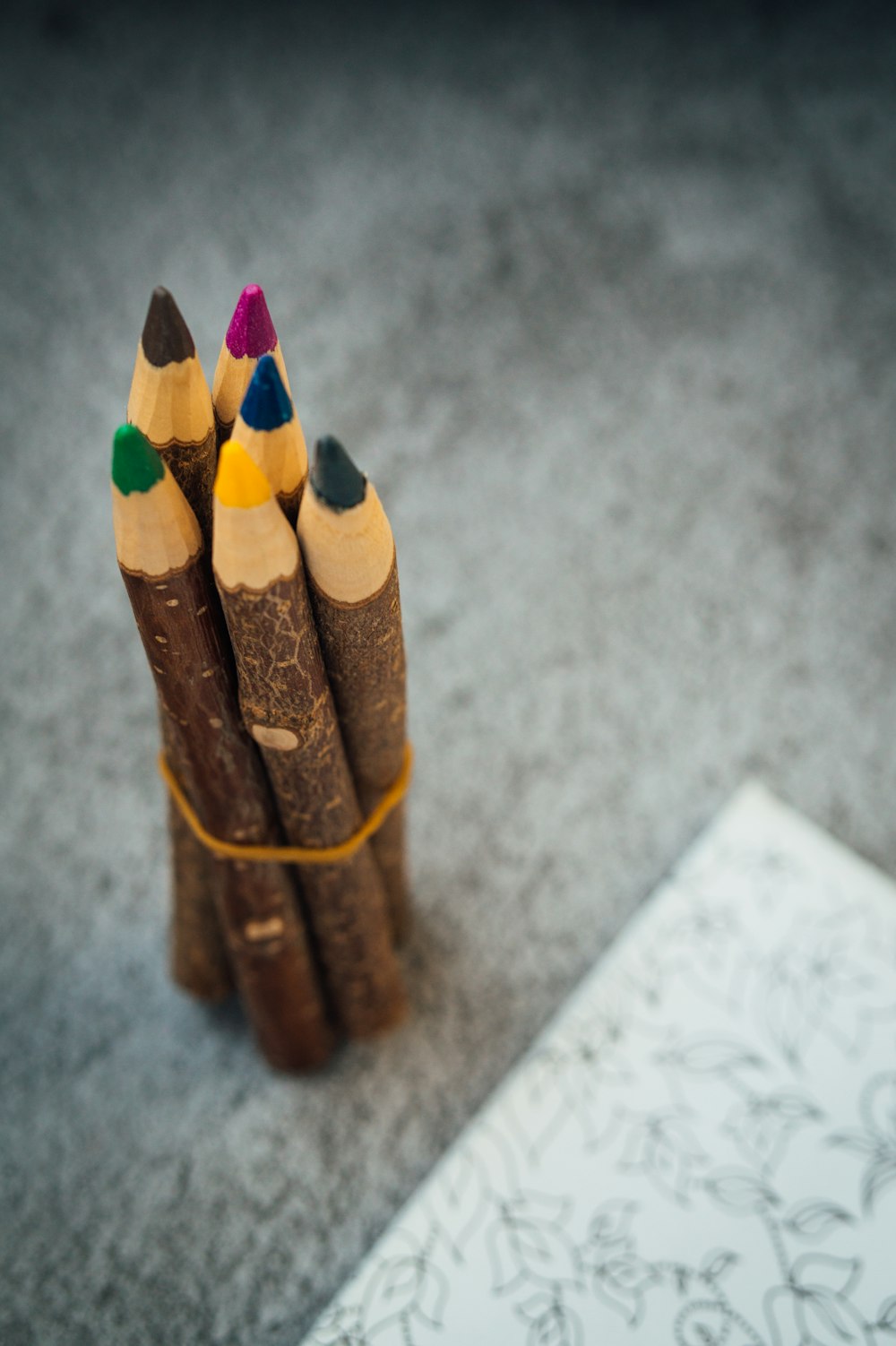 brown coloring pencils on gray surface