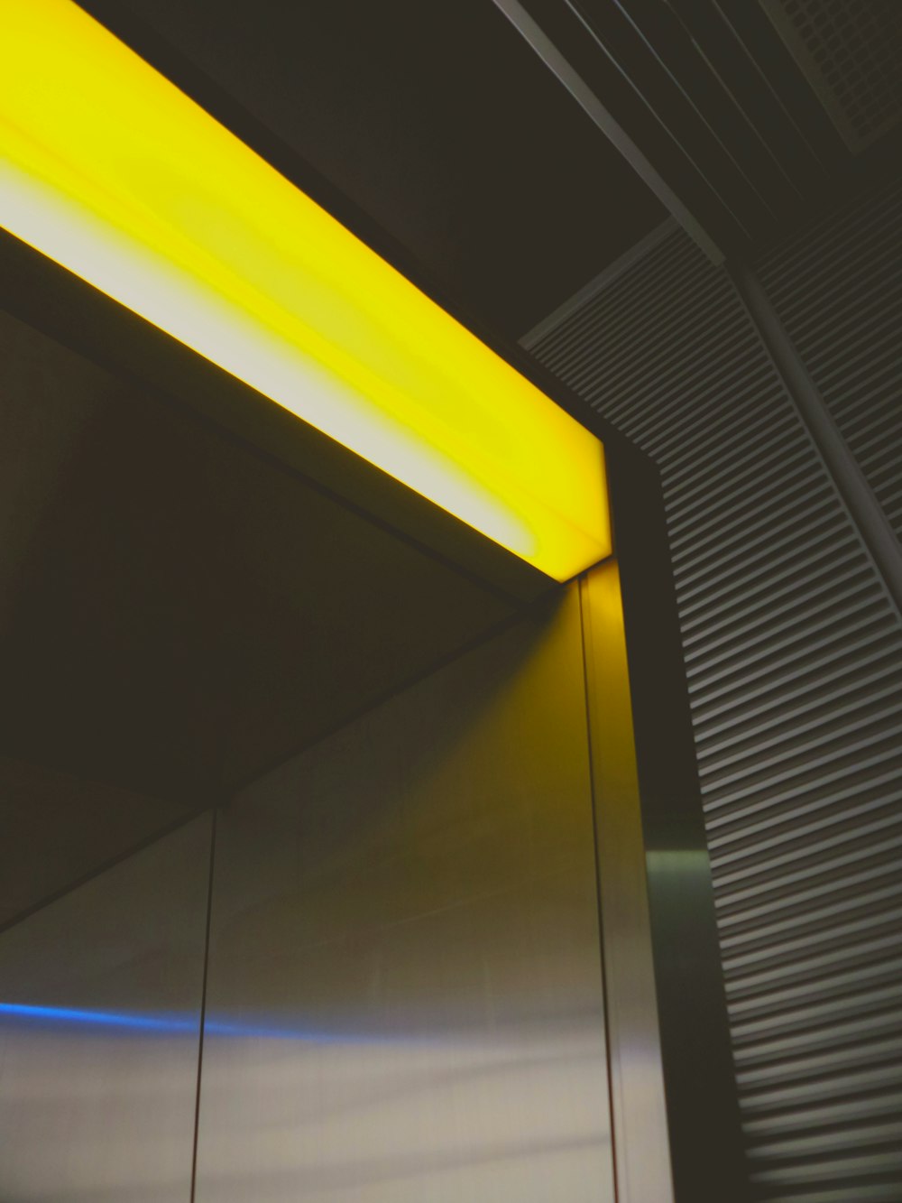 yellow and black ceiling with white window blinds