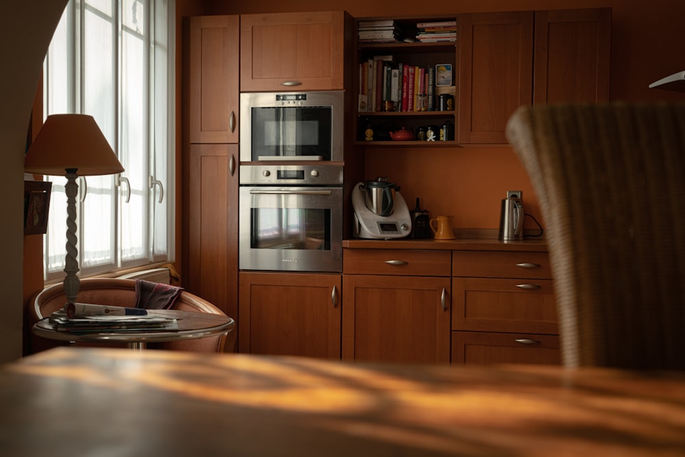 silver microwave oven on brown wooden cabinet