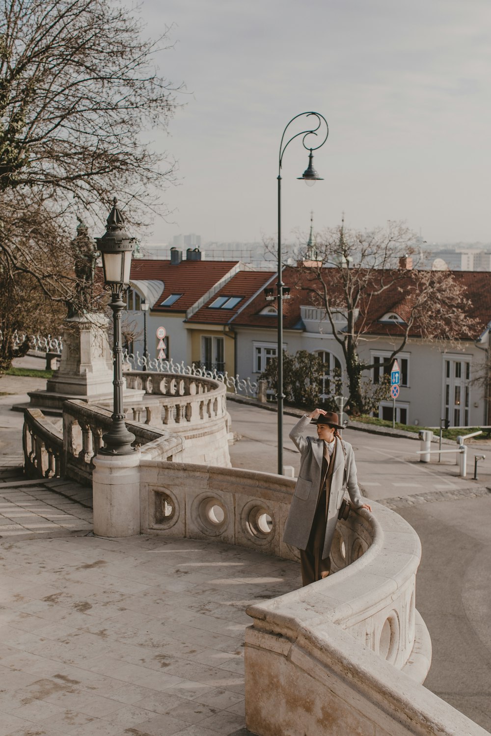 woman in white dress walking on sidewalk during daytime