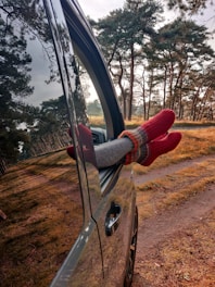 person in red sweater and red pants holding black steering wheel