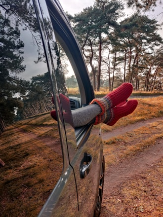 person in red sweater and red pants holding black steering wheel