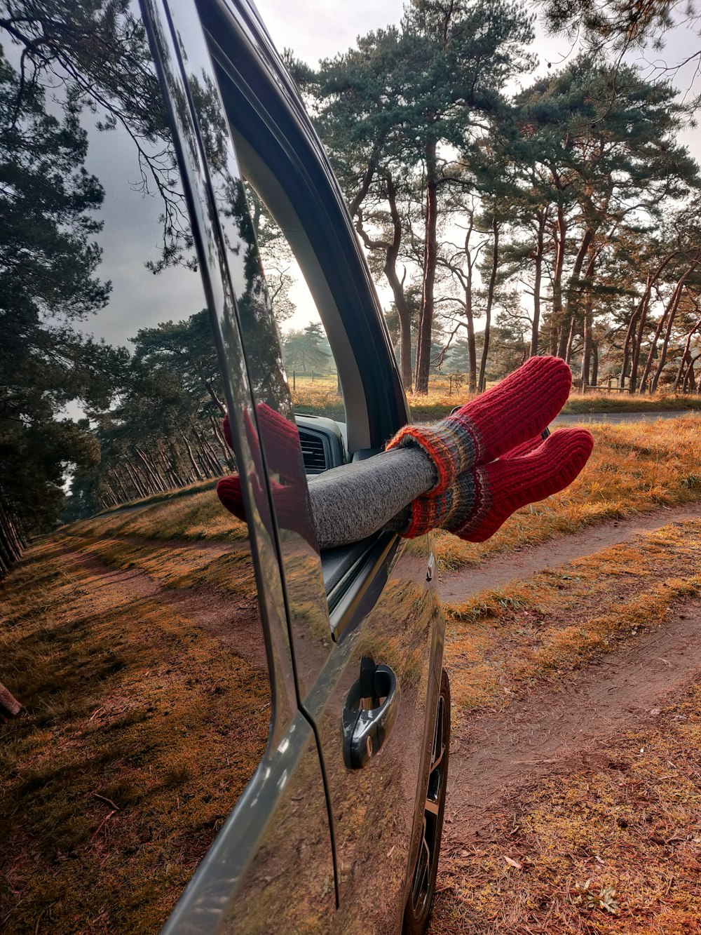 person in red sweater and red pants holding black steering wheel