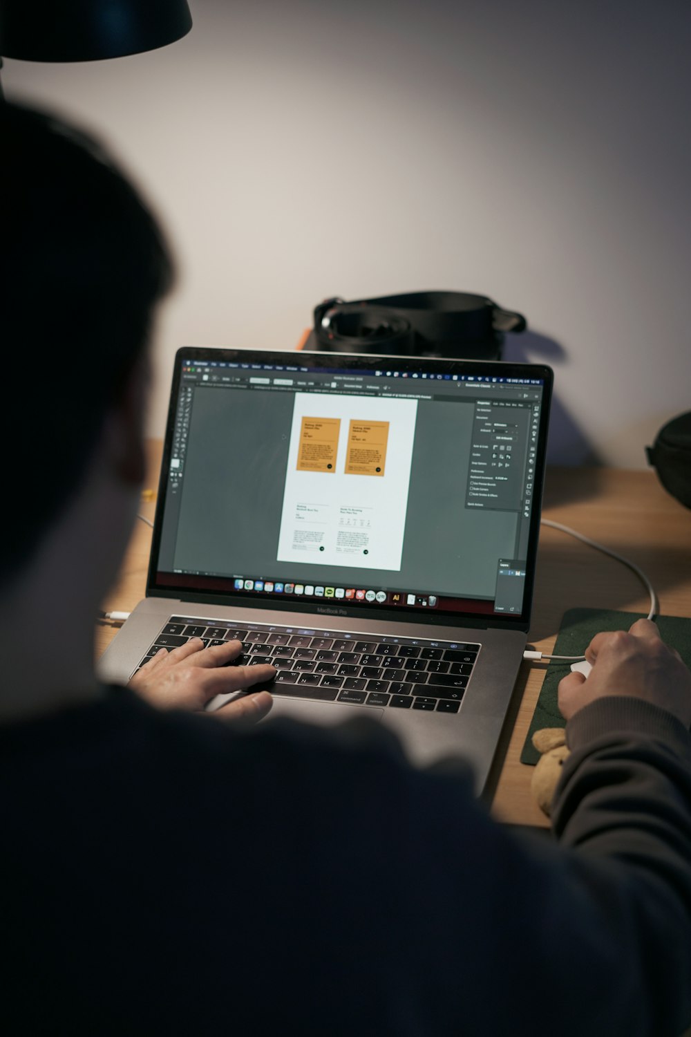 person using macbook pro on table