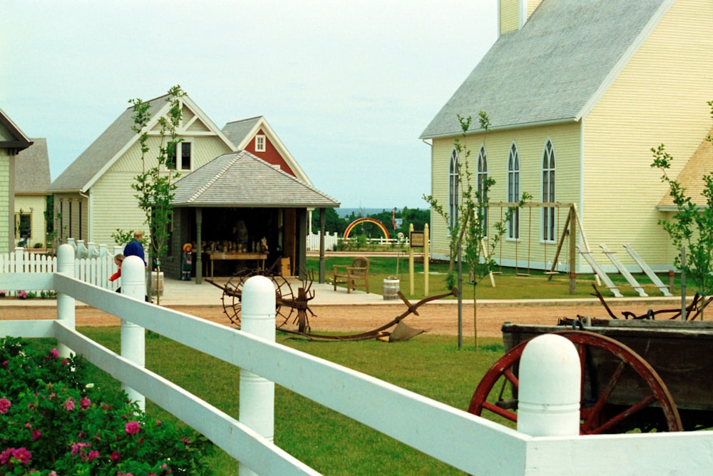 white wooden fence near white concrete house during daytime