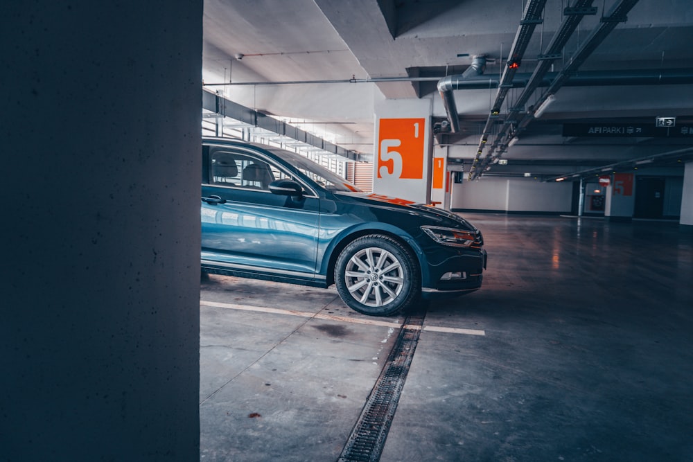 blue car parked in a parking lot