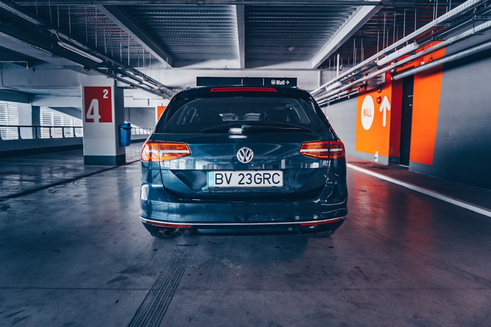 black bmw car parked beside red and white building