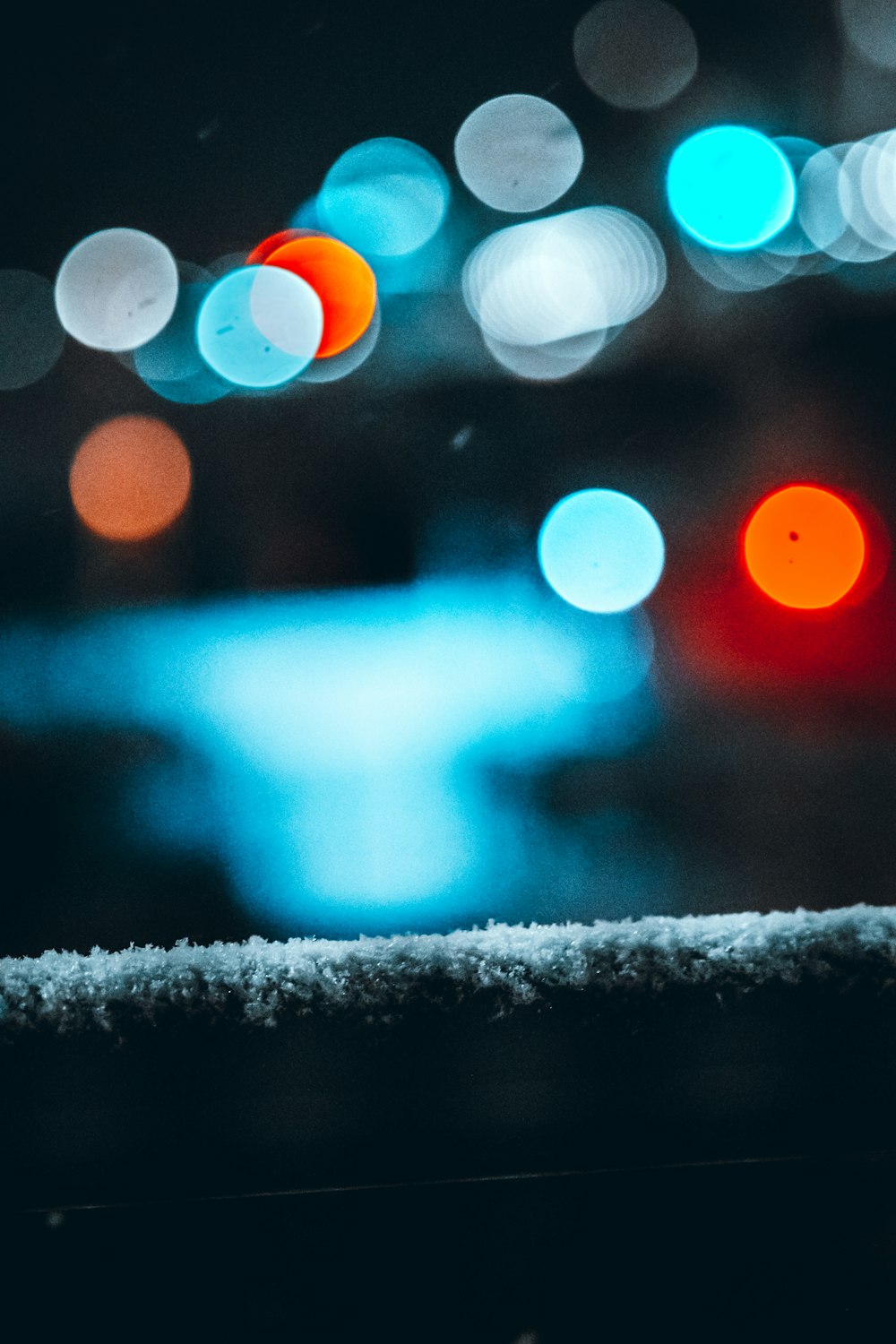 bokeh photography of snow covered road during night time