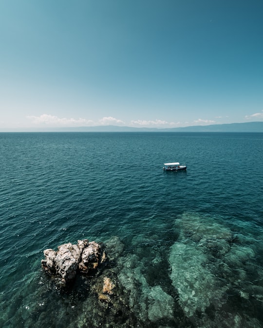 white boat on sea under blue sky during daytime in Ohrid North Macedonia