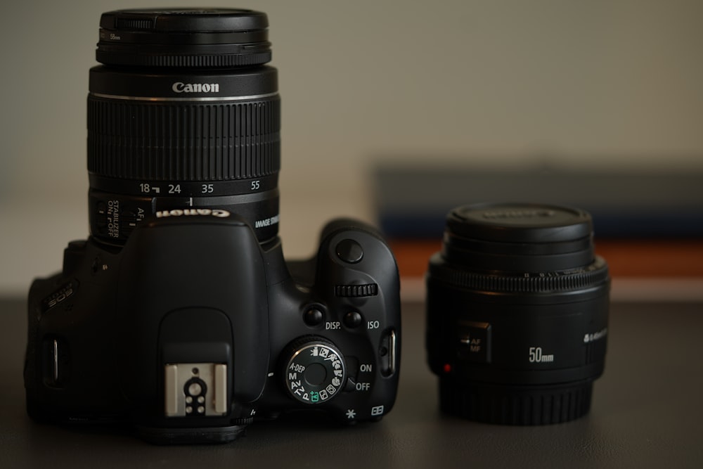 black nikon dslr camera on white table