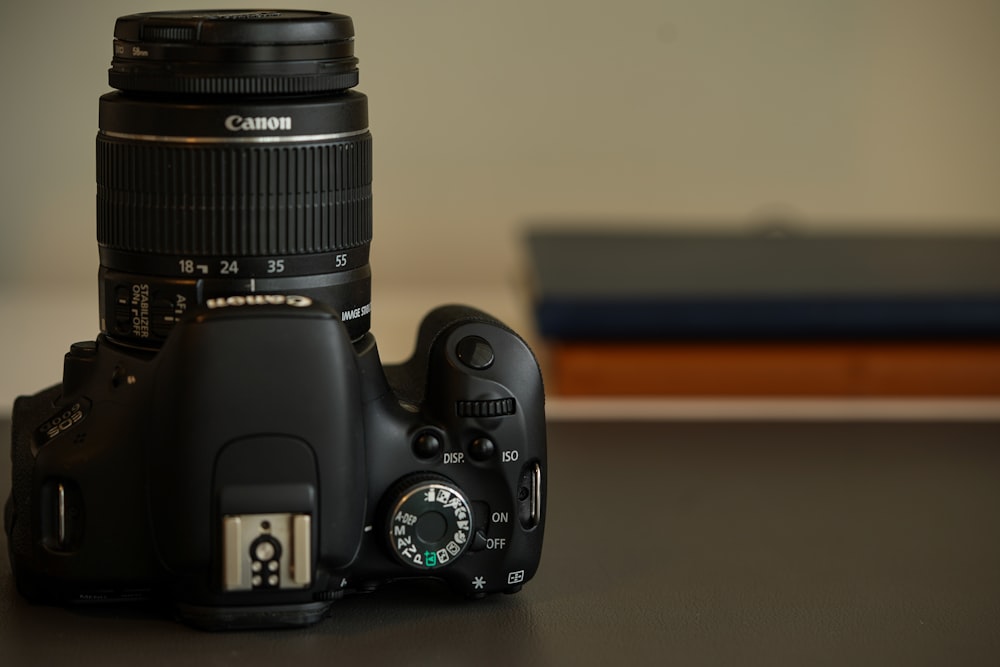 black nikon dslr camera on brown wooden table