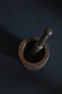 brown wooden mortar and pestle often used in herb preparation 
