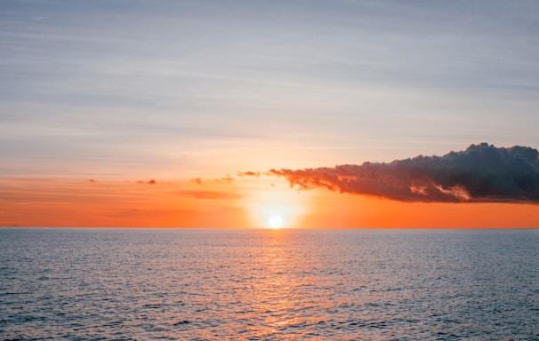 body of water during sunset