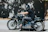 A happy motorcyclist wearing a black balaclava on a sunny day.