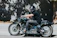 A happy motorcyclist wearing a black balaclava on a sunny day.