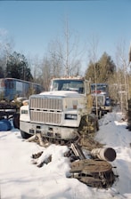 white truck on snow covered ground during daytime