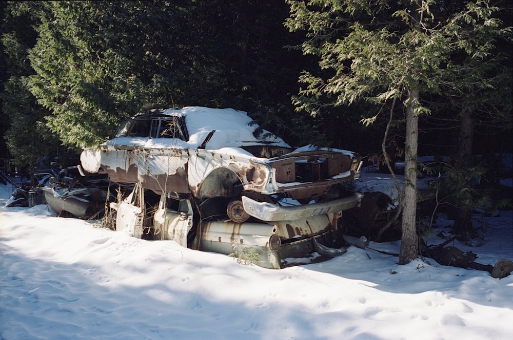 wrecked car on snow covered ground during daytime
