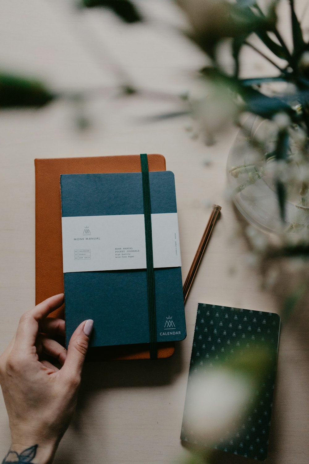 person holding blue and orange book