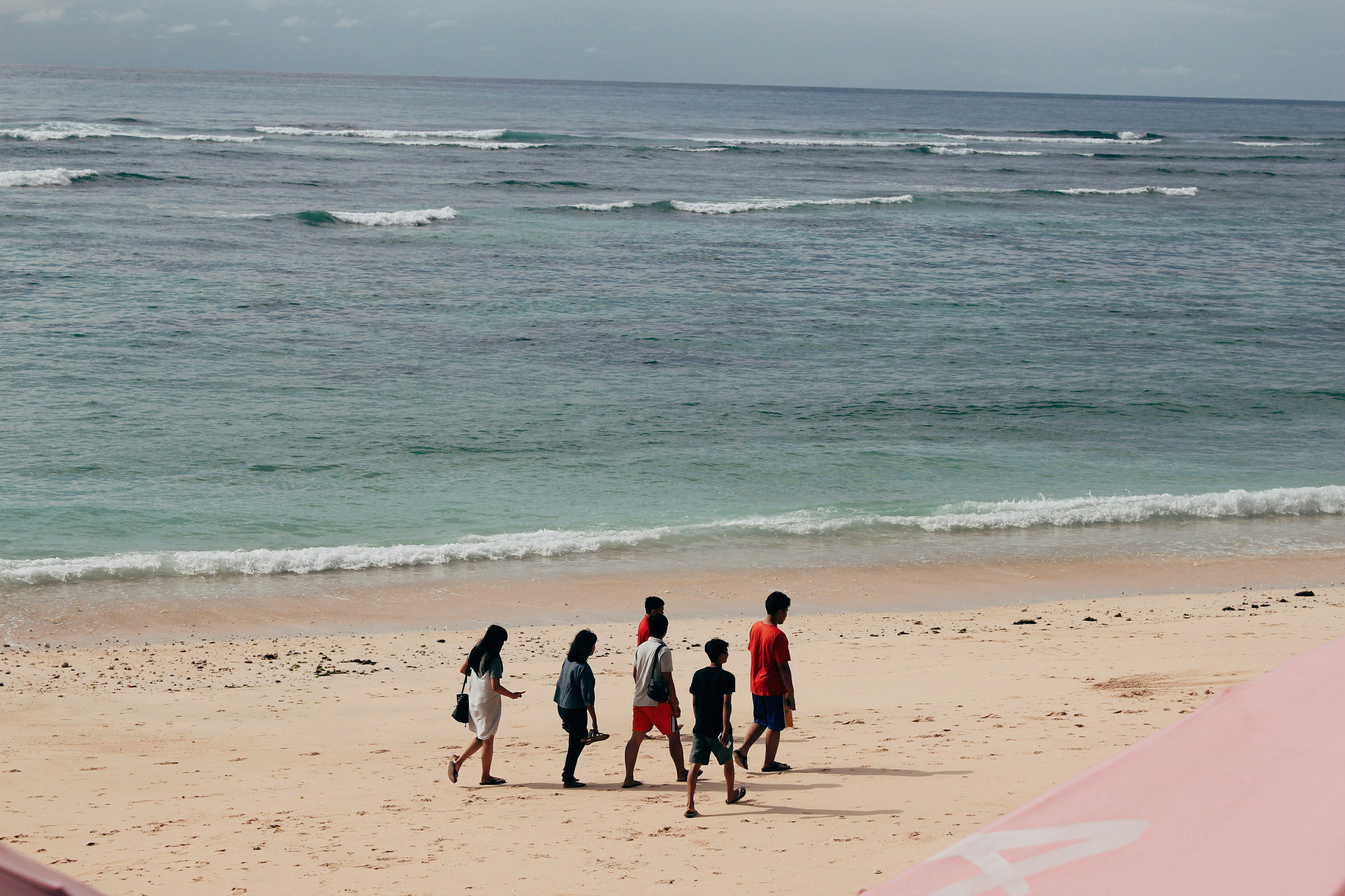 people walking on beach during daytime
