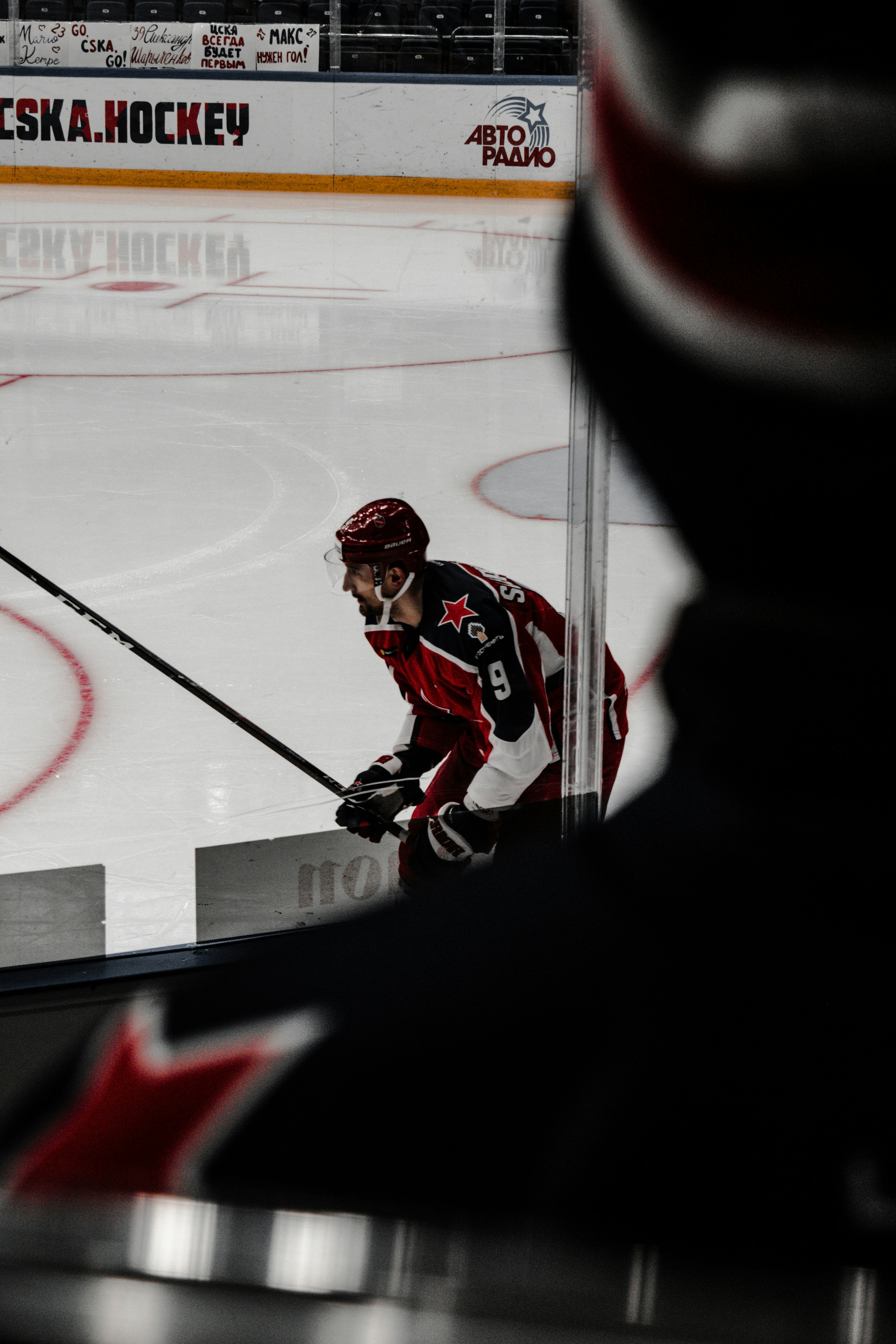 man in red and white ice hockey jersey playing hockey