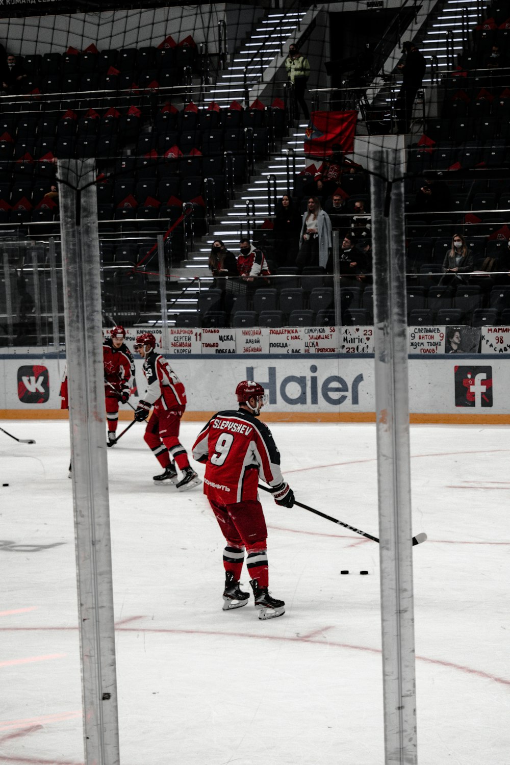 man in red ice hockey jersey playing hockey