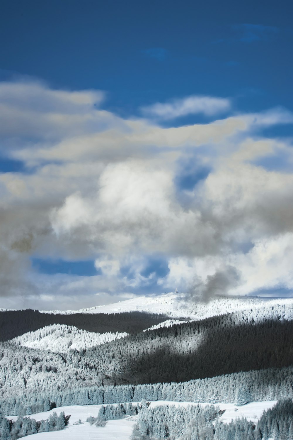 snow covered mountain under cloudy sky during daytime