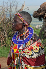 Colorful Maasai beadwork displayed on a traditional woven mat under bright sunlight.