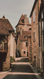 Historic stone buildings and narrow streets in a picturesque Aveyron village.