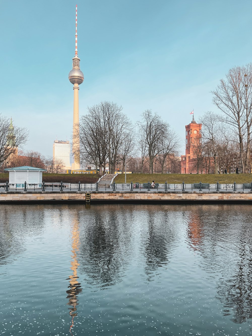 brown and white concrete building near body of water during daytime