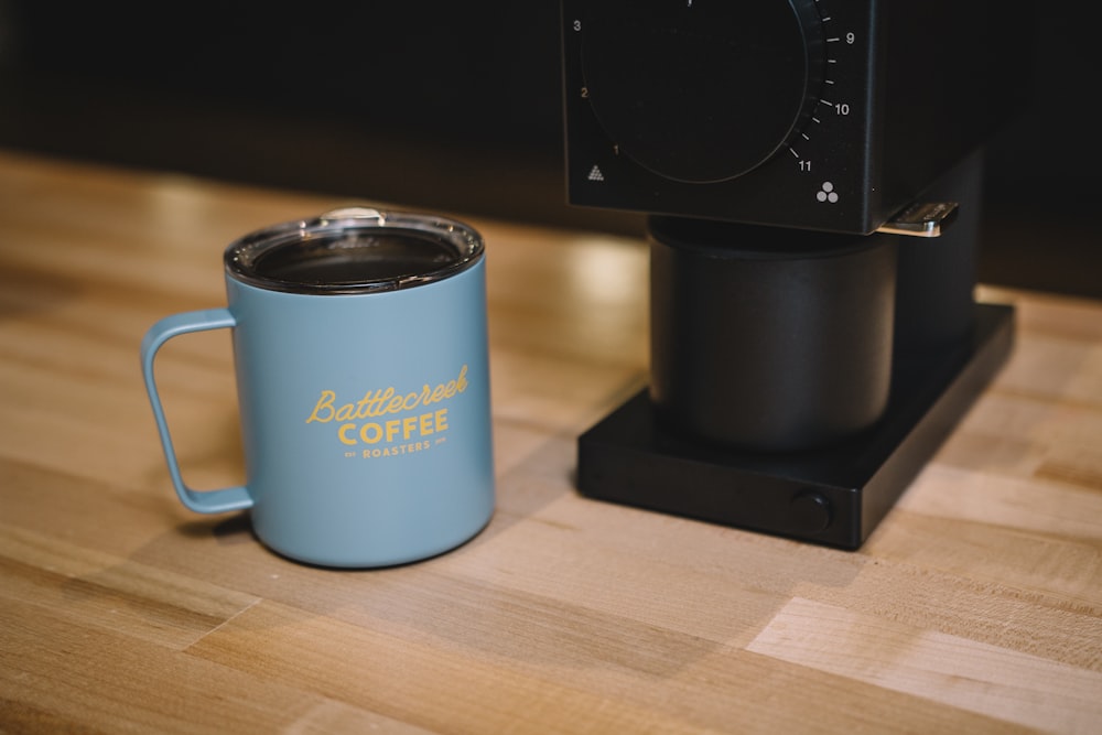 blue ceramic mug on brown wooden table