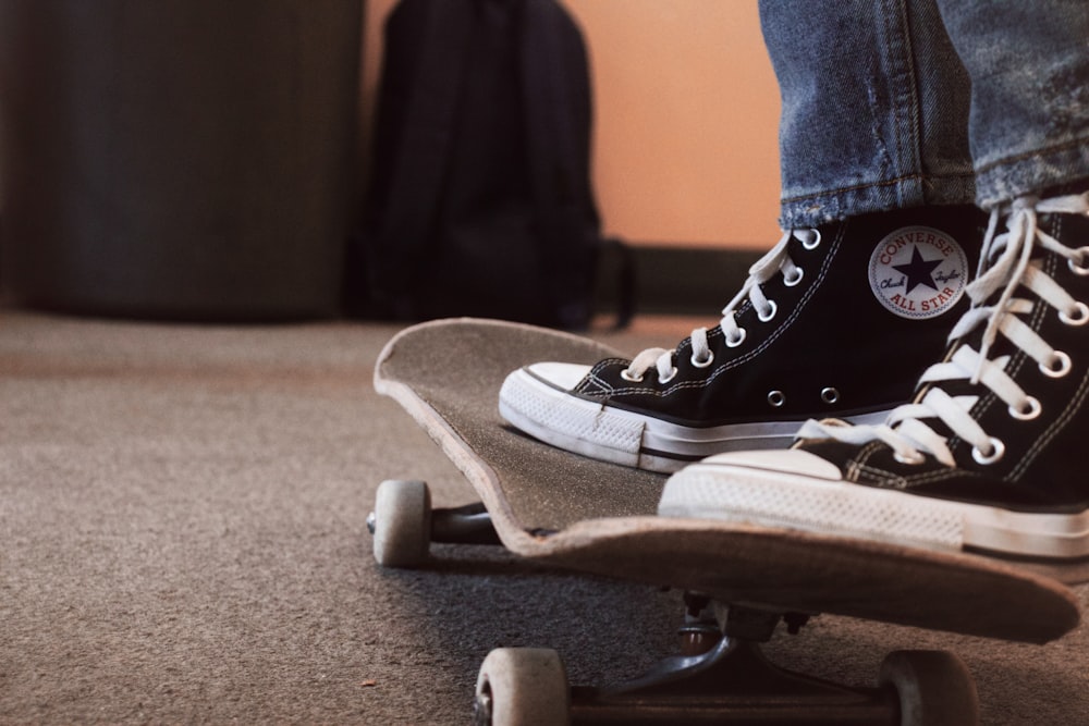 person wearing black converse all star high top sneakers photo – Free  Footwear Image on Unsplash