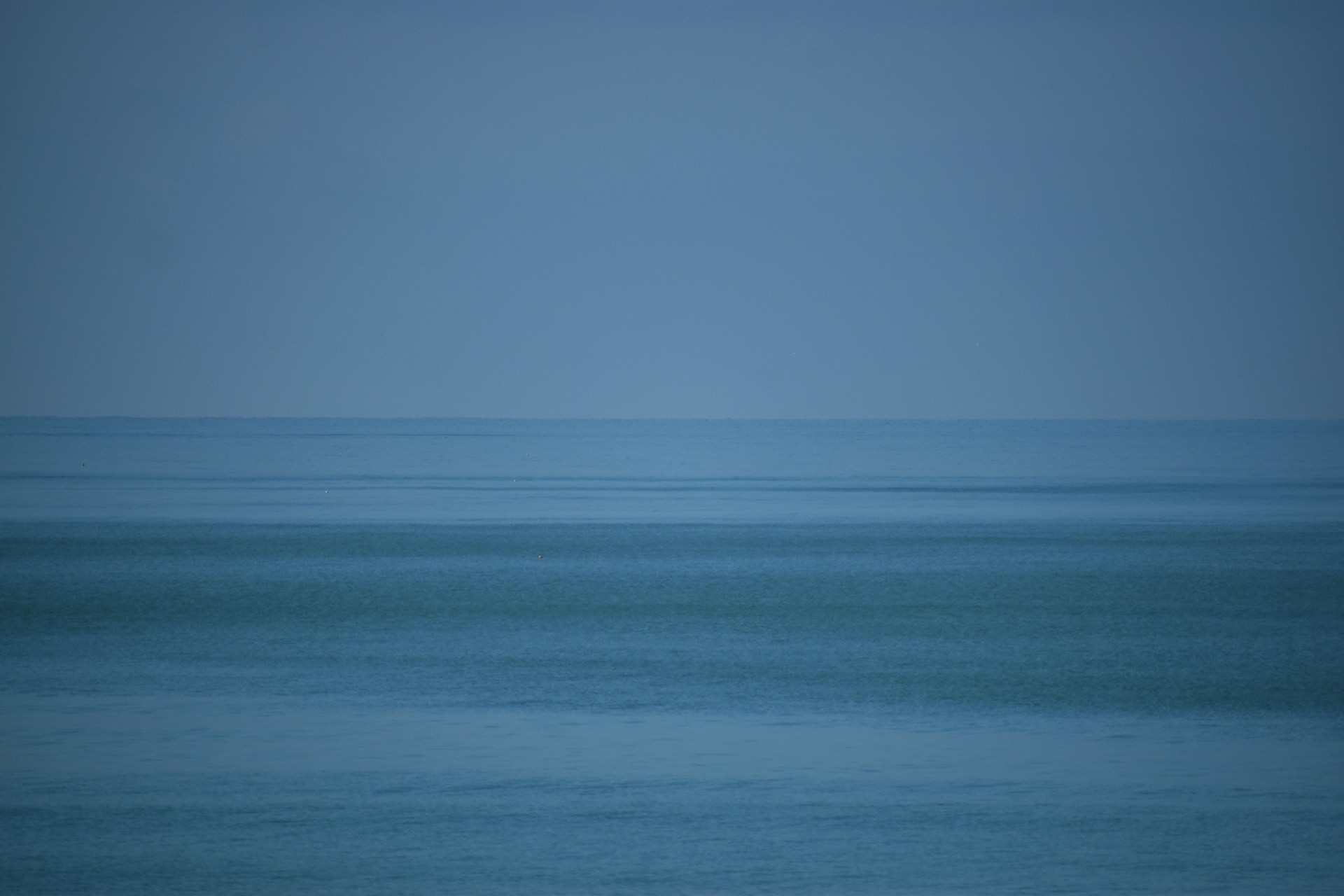 blue ocean water under blue sky during daytime