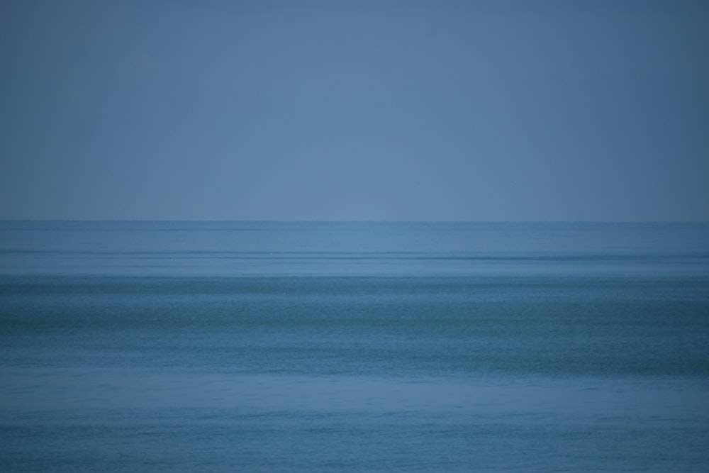 blue ocean water under blue sky during daytime