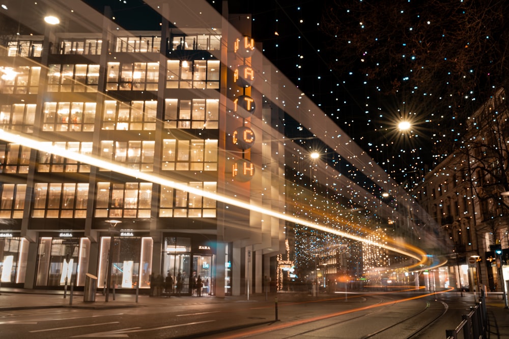 white concrete building with lights turned on during night time