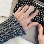 person wearing silver ring on left hand
