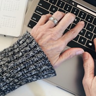 person wearing silver ring on left hand