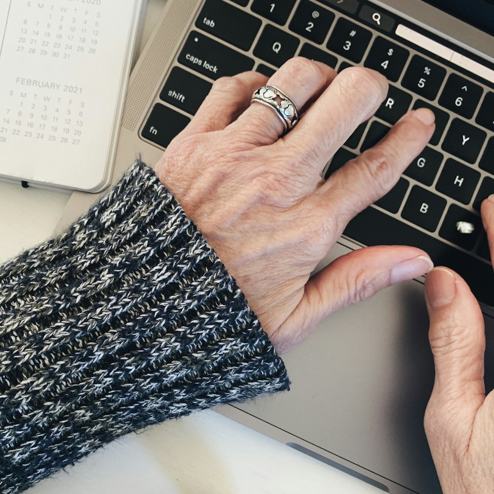 person wearing silver ring on left hand