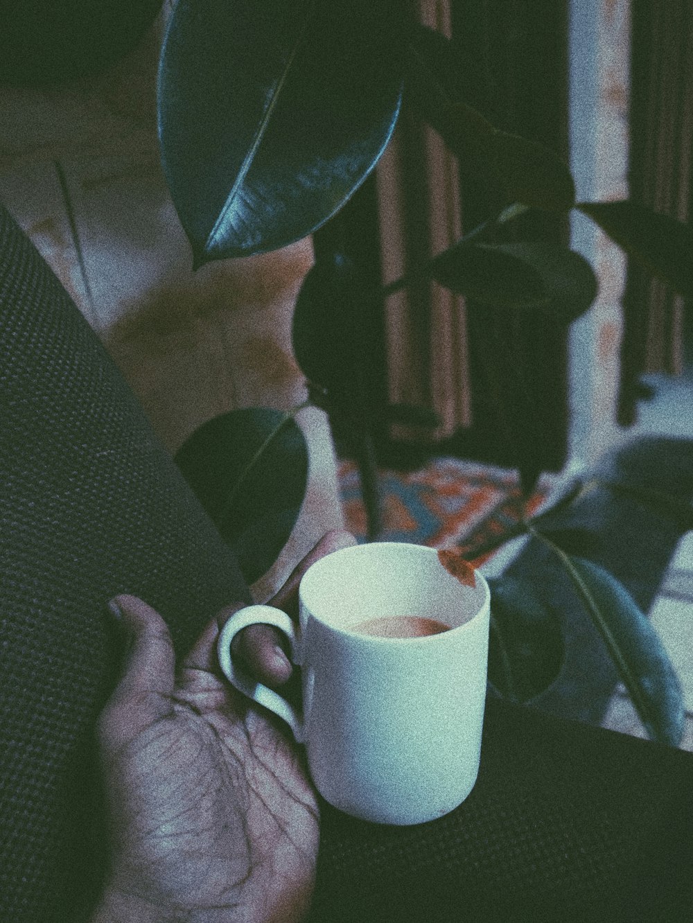 person holding white ceramic mug