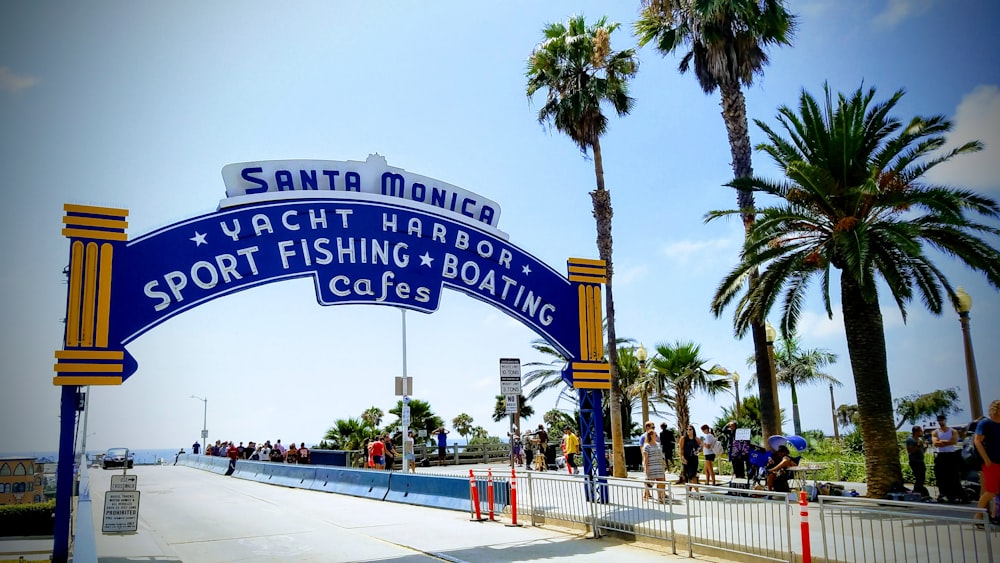 a blue and yellow sign that says santa monica yacht harbor sport fishing and boating clubs