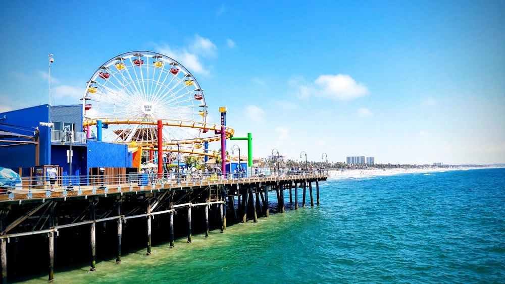 ferris wheel near body of water during daytime