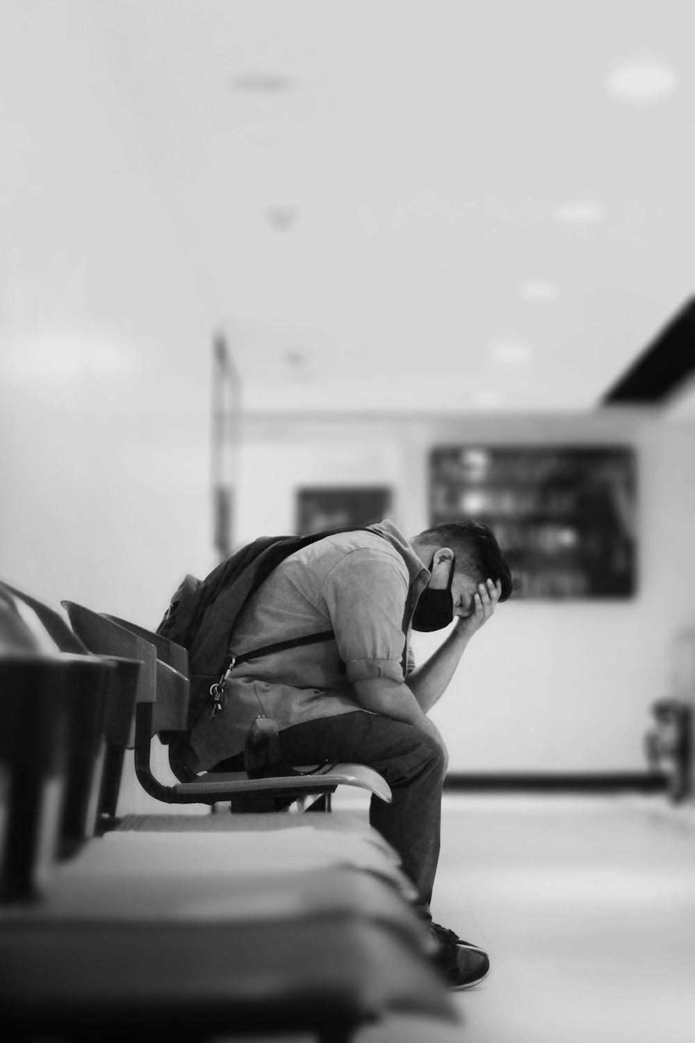 man in black jacket sitting on chair